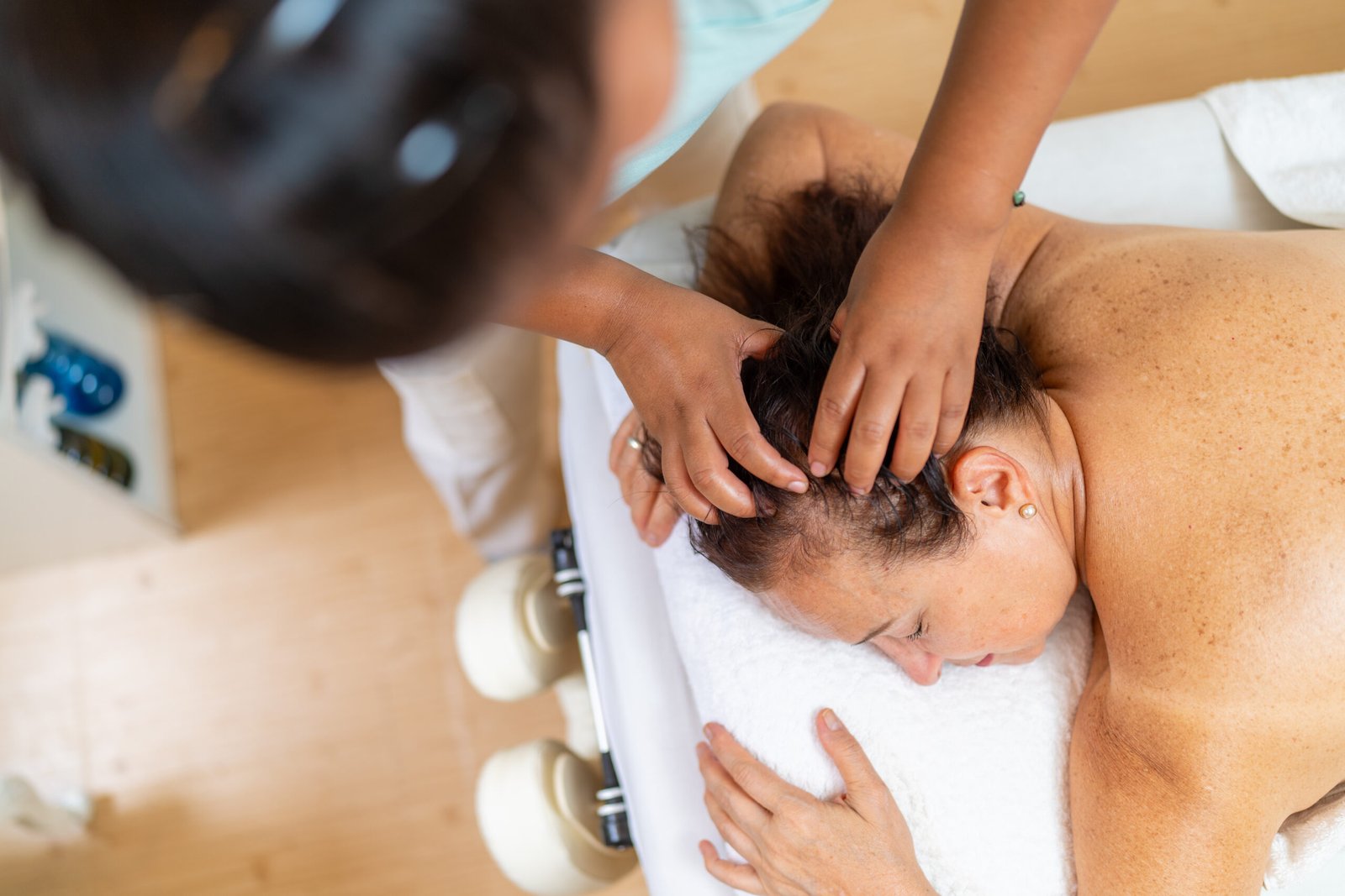 Top view of a cranial massage for a patient in a spa
